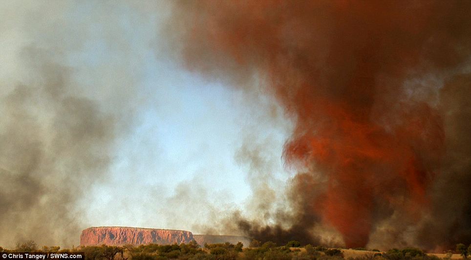Brewing storm: The fire whirl occurred in the Australian outback as the red cliffs show the area's trademark look
